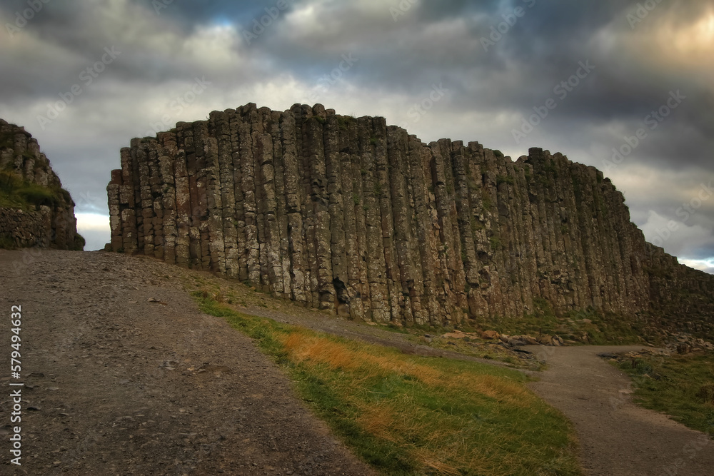 Basalt columns on the Giant's Causeway in Northern Ireland with dramatic cloudy sky