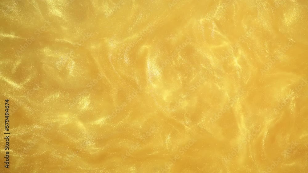 Yellow Golden Shiny Abstract Background. Paints, Acrylic, Glitter in Water. Yellow Golden Shiny Liquid Surface, Ripples, Waves. Yellow Golden Shiny Abstract Background. Paints, Acrylic, Glitter in Water. Yellow Golden Shiny Liquid Surface, Ripples, Waves.