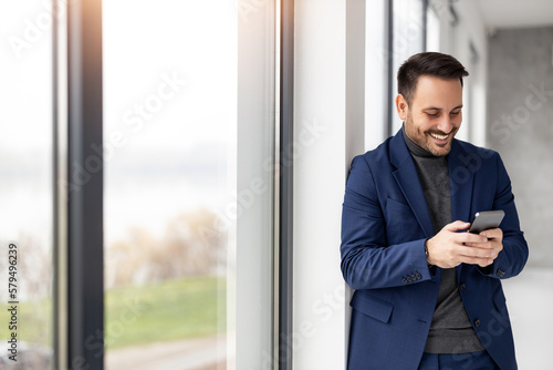 Smiling businessman at work in modern office
