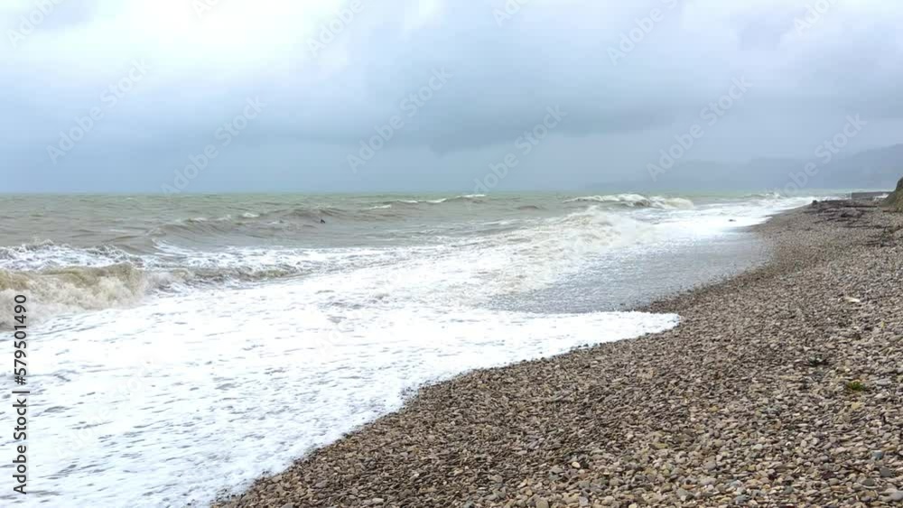 Powerful sea waves are crashing on the Black Sea coast. Waves splash on the beach with pebbles during a storm. Storm at sea. Panoramic view of the Black Sea. Russia. Sunset on the beach. 4K Powerful sea waves are crashing on the Black Sea coast. Waves splash on the beach with pebbles during a storm. Storm at sea. Panoramic view of the Black Sea. Russia. Sunset on the beach. 4K