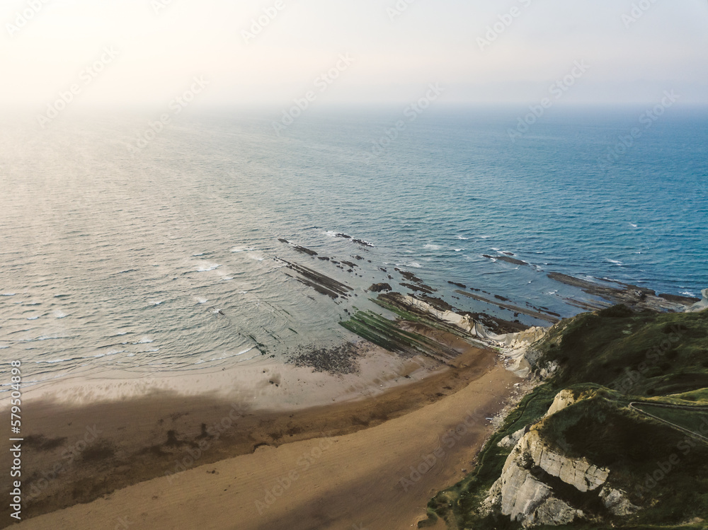 Famous rock formation at atxabiribil beach in bilbao - aerial shot