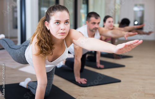 Portrait of woman maintaining healthy lifestyle, practicing pilates lesson at group class