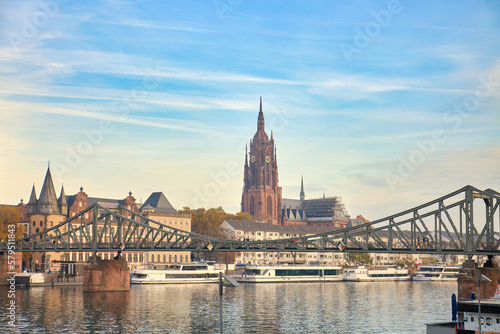 View of the dome of a cathedral over the iron bridge on the river Main, Frankfurt, Germany.
