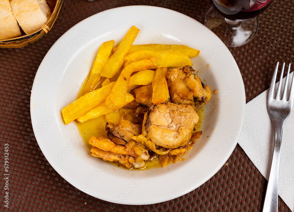 Fresh portion of fried chicken with potatoes served on plate.