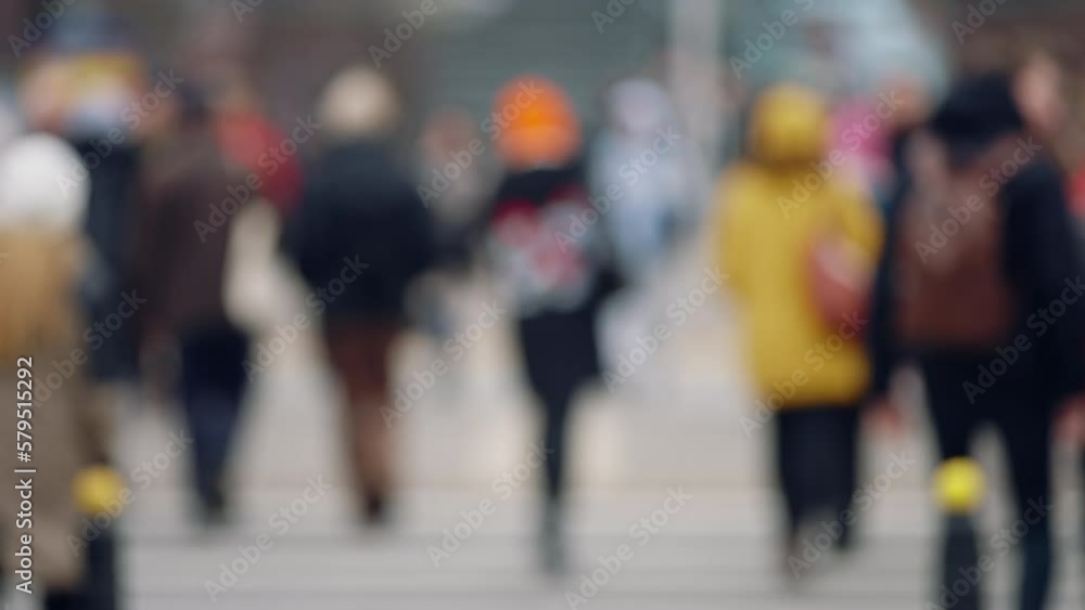 Bokeh blurred people crowd walking crossing busy urban street slow motion, city life, lot of pedestrians crowded crosswalk, rush hour intersection sidewalk autumn day. Blurry cityscape background Bokeh blurred people crowd walking crossing busy urban street slow motion, city life, lot of pedestrians crowded crosswalk, rush hour intersection sidewalk autumn day. Blurry cityscape background