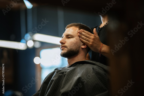 portrait of a young guy groom at the training camp in the barbershop