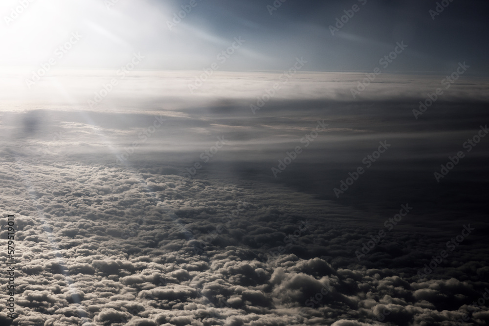 Heaven with sun light rays or beams bursting from clouds in blue sky. Spiritual religious background. Realistic tranquil cloudscape view, beautiful skyey paradise backdrop