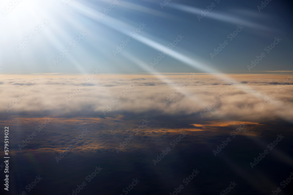 Heaven with sun light rays or beams bursting from clouds in blue sky. Spiritual religious background. Realistic tranquil cloudscape view, beautiful skyey paradise backdrop