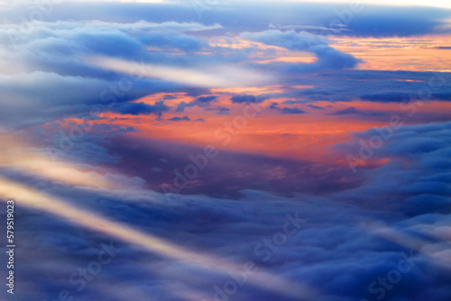 Heaven with sun light rays or beams bursting from clouds in blue sky. Spiritual religious background. Realistic tranquil cloudscape view, beautiful sky paradise backdrop