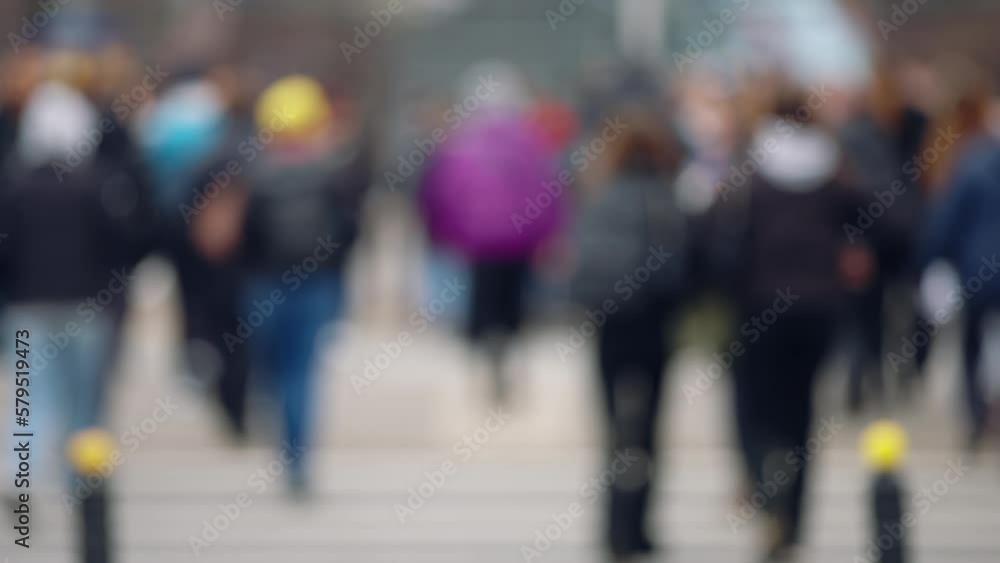 Bokeh blurred people crowd walking crossing busy urban street slow motion, city life, lot of pedestrians crowded crosswalk, rush hour intersection sidewalk autumn day. Blurry cityscape background Bokeh blurred people crowd walking crossing busy urban street slow motion, city life, lot of pedestrians crowded crosswalk, rush hour intersection sidewalk autumn day. Blurry cityscape background