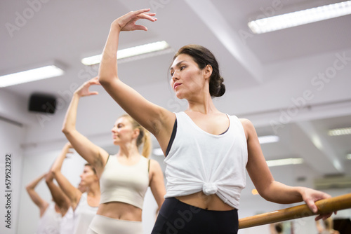 Woman practicing ballet elements in dance class