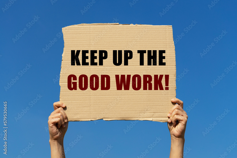 Keeo up the good work text on box paper held by 2 hands with isolated