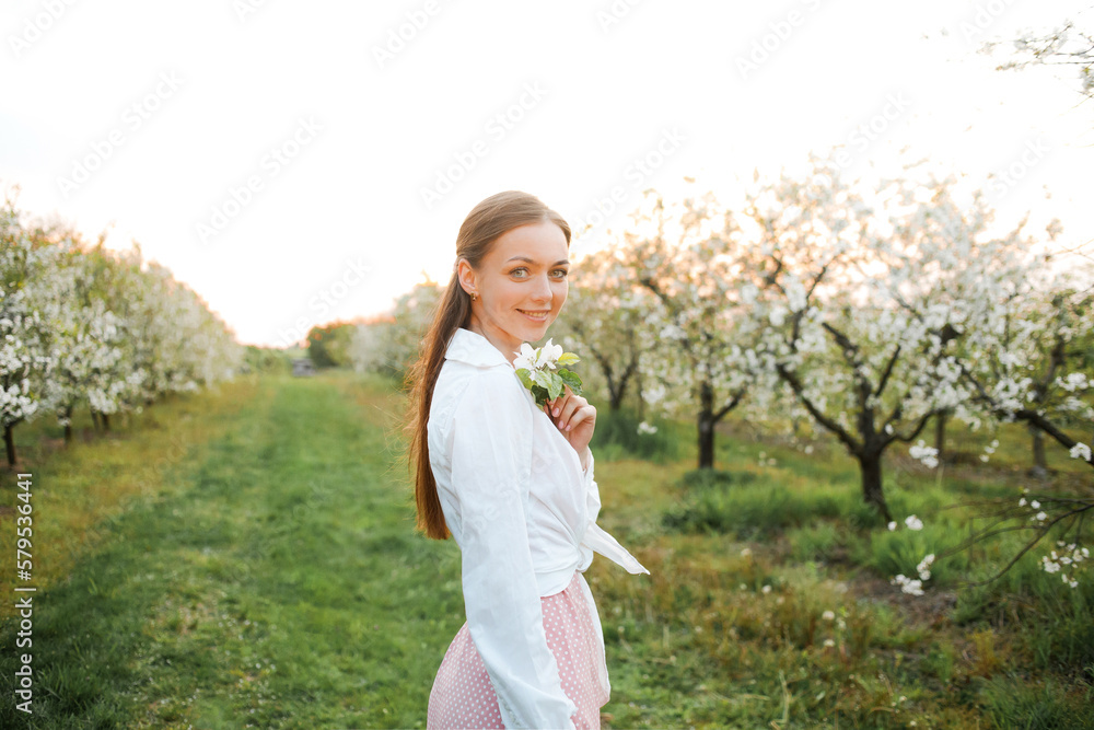 Portrait of happy woman. Blooming garden in spring. Portrait of happy woman. Blooming garden in spring.