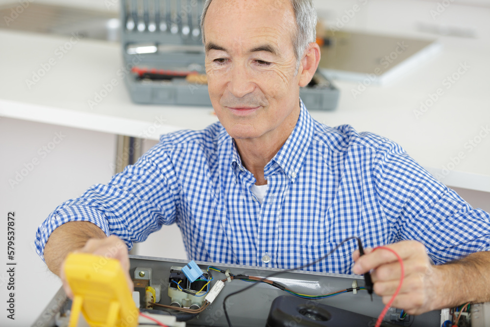 a senior man checking voltage