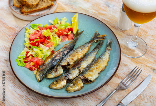 Barbecue sardines served with vegetable salad, delicious seafood appetizer