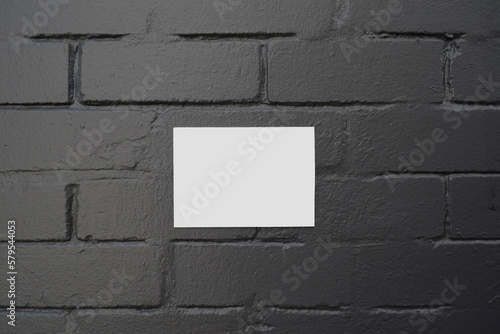 White Box over a black brick wall