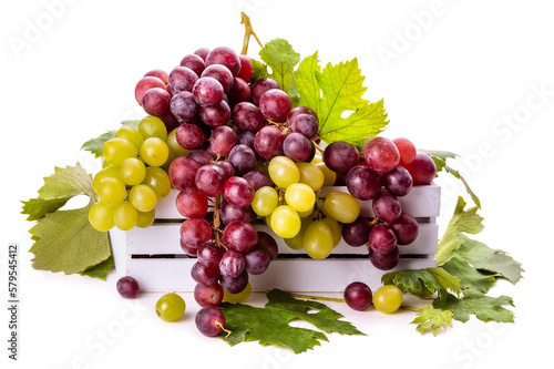 White and pink grapes with green leaves in a white wooden box. Isolate on white background