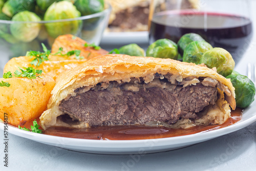 Beef Wellington with mushroom Duxelles, served with brussels sprouts and Chateau potato, closeup
