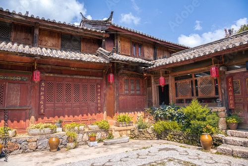 August 7, 2021, Lijiang, China. Landscape view of a street in lijiang old town lined with traditional wooden houses and some decorative red lanterns