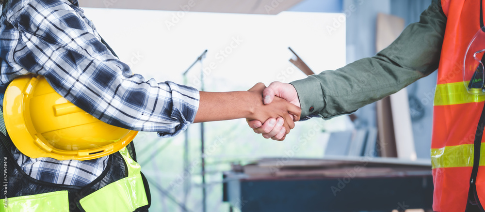 Group of multi ethnic engineer construction site worker meeting at workplace, Architects working together at construction site to remodeling home or building. Shaking hands