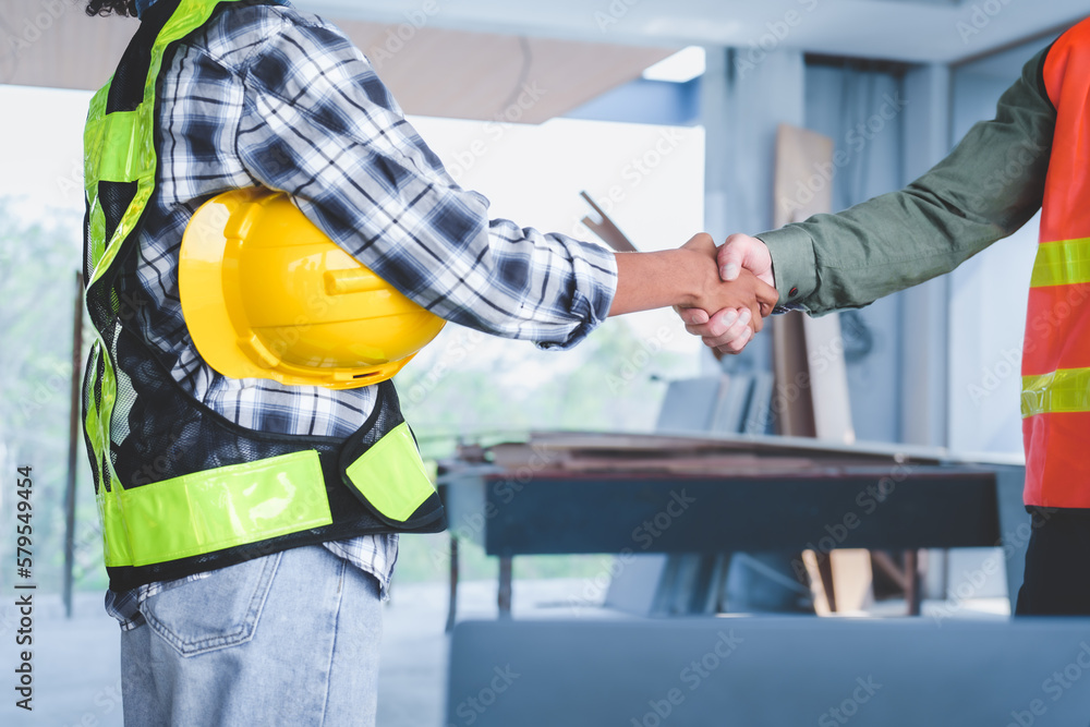 Group of multi ethnic engineer construction site worker meeting at workplace, Architects working together at construction site to remodeling home or building. Shaking hands Group of multi ethnic engineer construction site worker meeting at workplace, Architects working together at construction site to remodeling home or building. Shaking hands