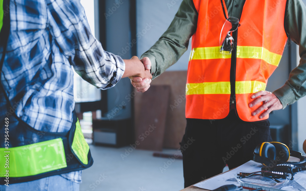 Group of multi ethnic engineer construction site worker meeting at workplace, Architects working together at construction site to remodeling home or building. Shaking hands Group of multi ethnic engineer construction site worker meeting at workplace, Architects working together at construction site to remodeling home or building. Shaking hands