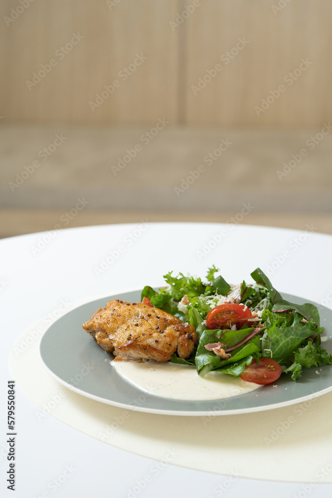 grilled chicken caesar salad on table grilled chicken caesar salad on table