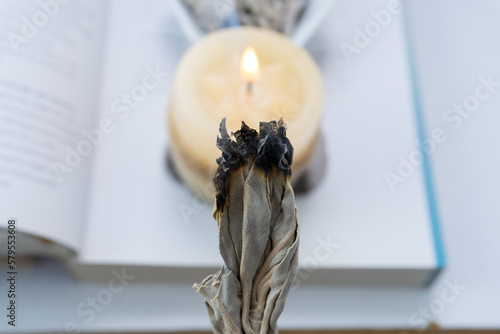 Ritual with white sage smoke and white candle photo