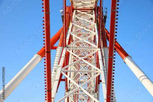 Fototapeta Naklejka Na Ścianę i Meble -  Beautiful large Ferris wheel against blue sky, bottom view