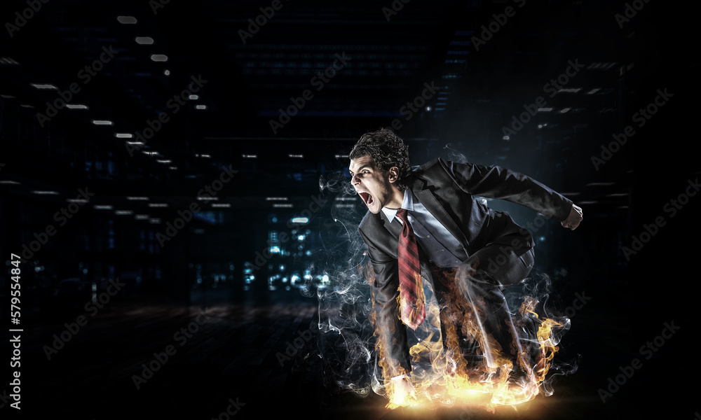 Obraz premium Determined businessman leaving fire trails on asphalt