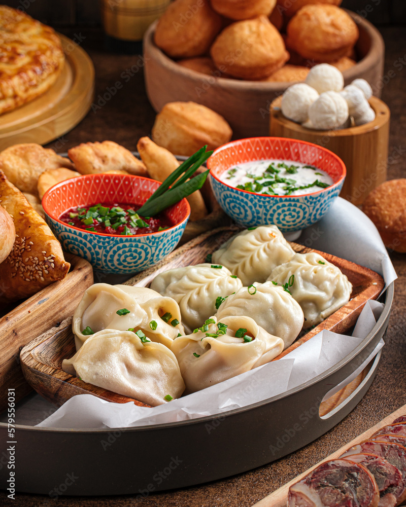 Set of assorted oriental cuisine dishes with samsa and manti Set of assorted oriental cuisine dishes with samsa and manti