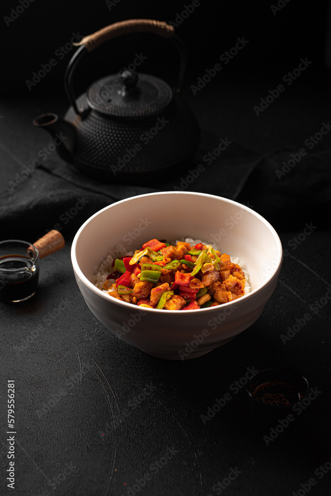 Portion of chinese gong bao chicken with rice and peanuts Portion of chinese gong bao chicken with rice and peanuts