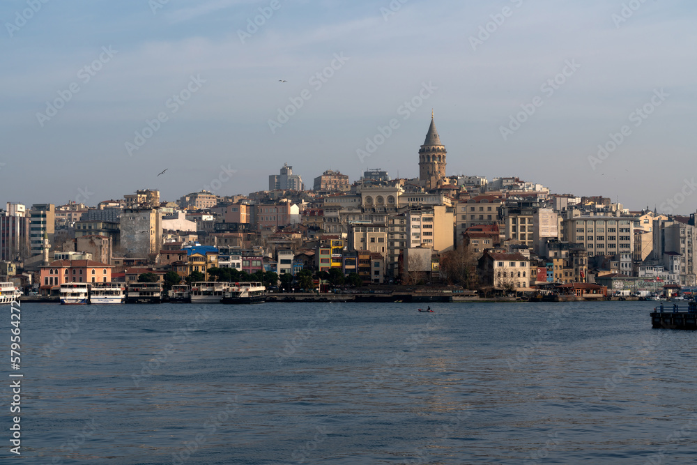 View of the Beyoglu district in Istanbul and the Galata Tower from the waters of the Golden Horn Bay on a sunny day, Istanbul, Turkey