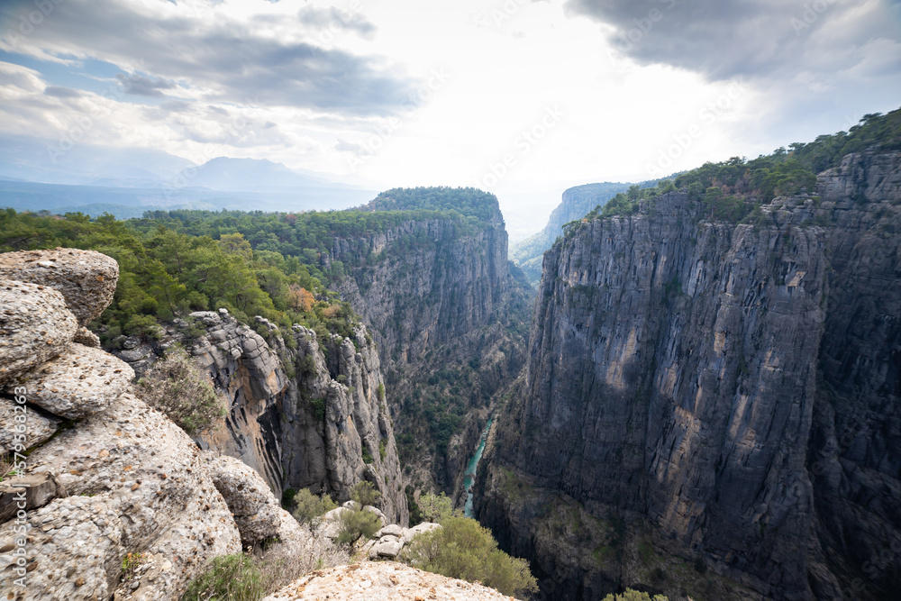 Mountain valleys and a little blue stream flowing between the rocks Mountain valleys and a little blue stream flowing between the rocks