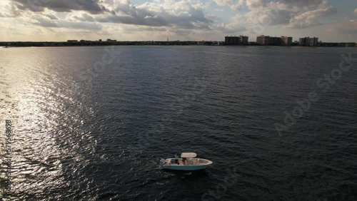 Wallpaper Mural An aerial view of the Atlantic Ocean off a Fort Lauderdale, Florida beach on a beautiful day with blue skies. There is a boat anchored as the camera truck right and pan left circling the vessel. Torontodigital.ca