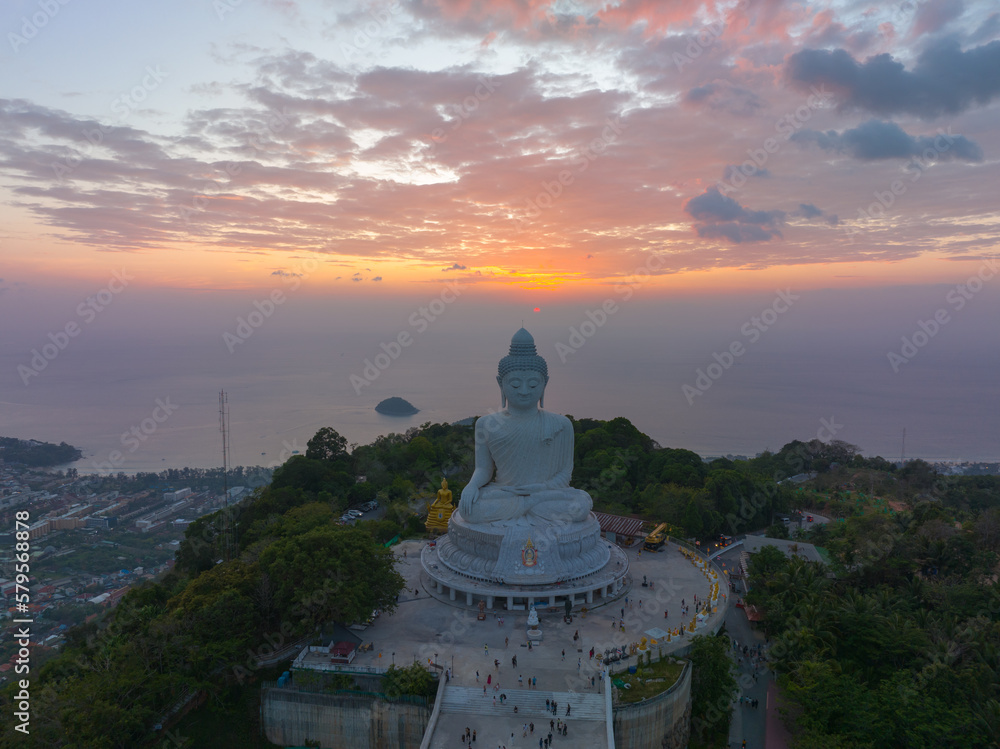 aerial view Phuket big Buddha in beautiful sunset..the sun shines through the clouds impact on ocean surface.The beauty of the statue fits perfectly with the charming nature..cloud scape background..