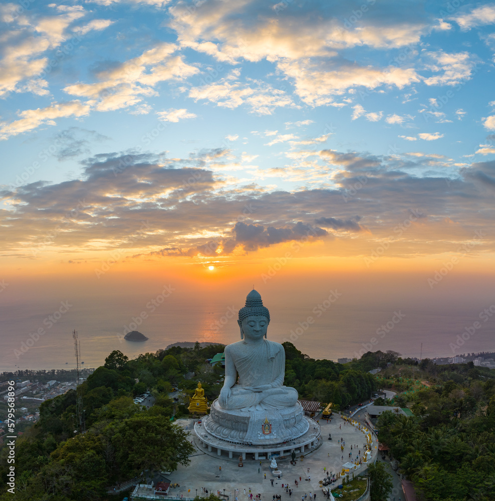 aerial view Phuket big Buddha in beautiful sunset..the sun shines through the clouds impact on ocean surface.The beauty of the statue fits perfectly with the charming nature..cloud scape background.. aerial view Phuket big Buddha in beautiful sunset..the sun shines through the clouds impact on ocean surface.The beauty of the statue fits perfectly with the charming nature..cloud scape background..