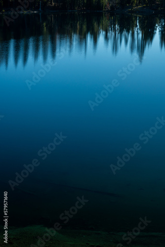 Reflection of Edges of Pine Trees in Shallow Blue Waters of Summit Lake