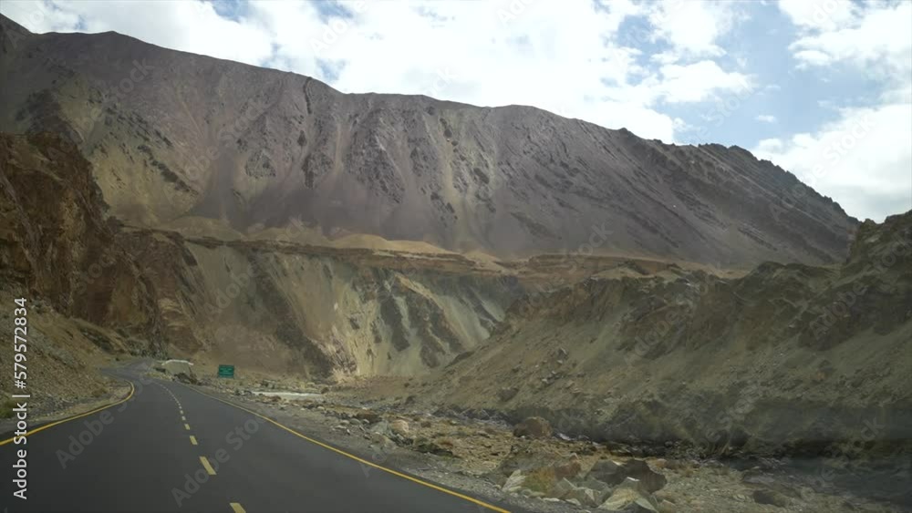 Car driving on the road to Leh Ladakh. Inside view of a car. Beautiful scenery on both sides of the road are mountains and blue sky Car driving on the road to Leh Ladakh. Inside view of a car. Beautiful scenery on both sides of the road are mountains and blue sky