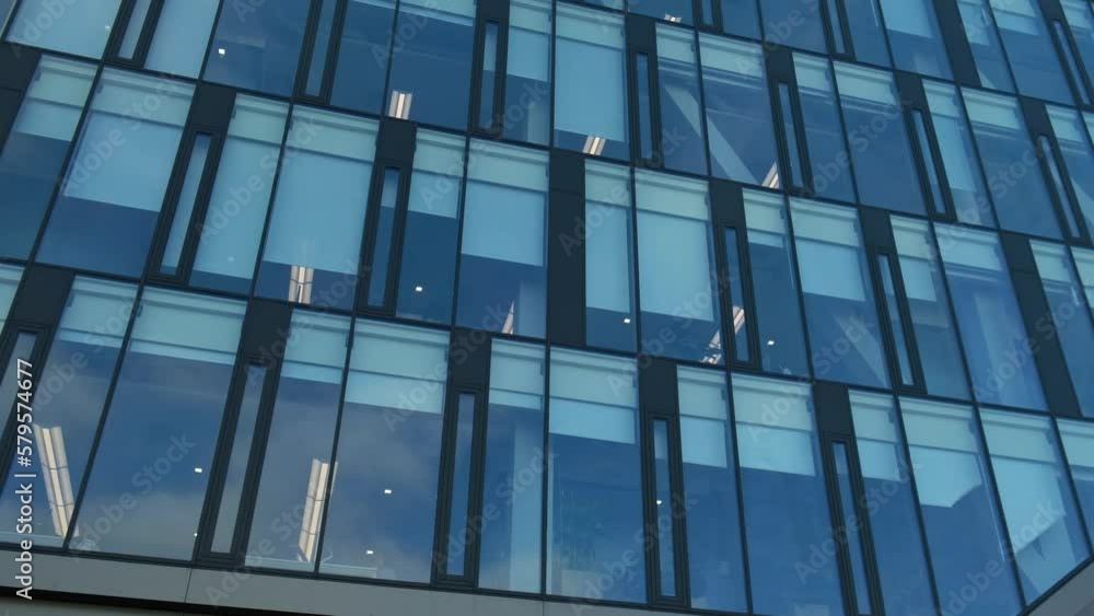Modern office building exterior with glass facade on clear sky background. Transparent glass wall of office building. Element of facade of modern European building Commercial office buildings Modern office building exterior with glass facade on clear sky background. Transparent glass wall of office building. Element of facade of modern European building Commercial office buildings