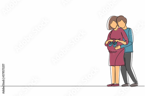 Continuous one line drawing cute pregnant woman and her husband holding baby shoes and hugging tummy. Pregnant woman holding baby shoes while husband touching her belly. Single line draw design vector