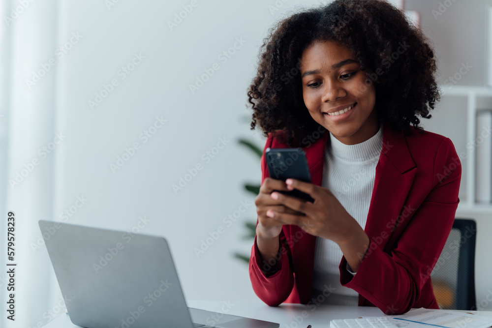 happy young businesswoman African American siting on the chiar cheerful demeanor raise holding coffee cup smiling looking laptop screen.Making opportunities female working successful in the office.
happy young businesswoman African American siting on the chiar cheerful demeanor raise holding coffee cup smiling looking laptop screen.Making opportunities female working successful in the office.