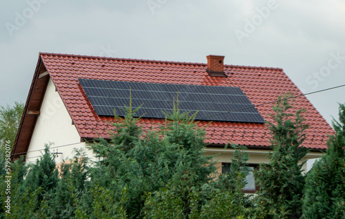 House roof with photovoltaic modules. Historic farm house with modern solar panels on roof and wall High quality photo photo