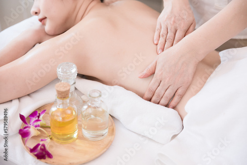 Young Asian woman getting Relaxing oil massage at beauty spa salon. Massage for health