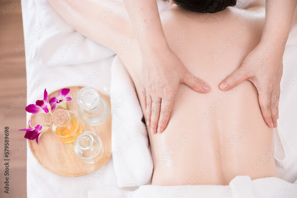 Young Asian woman getting Relaxing oil massage at beauty spa salon. Massage for health Young Asian woman getting Relaxing oil massage at beauty spa salon. Massage for health