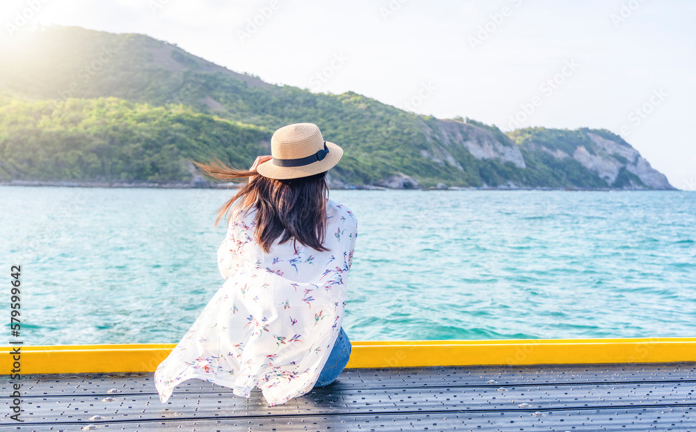 Back view of a woman watching views on tropical beach travel summer holidays. Young girl enjoy traveling to exotic nature in leisure time. Resting and relaxation in nature. Summer vacations concept