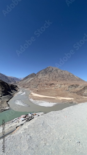 Sangam, Confluence of Zanskar and Indus river near Leh Ladakh, India shows its 2 color during summer time © Nhan