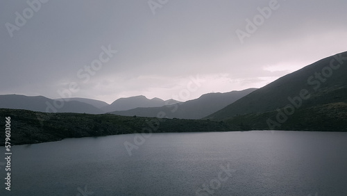 The rugged beauty of the northern mountains. A beautiful lake in the mountains. Tranquil water surface