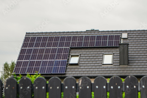 House roof with photovoltaic modules. Historic farm house with modern solar panels on roof and wall High quality photo photo