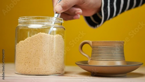 Wallpaper Mural slow motion of pouring brown sugar in a tea cup  Torontodigital.ca